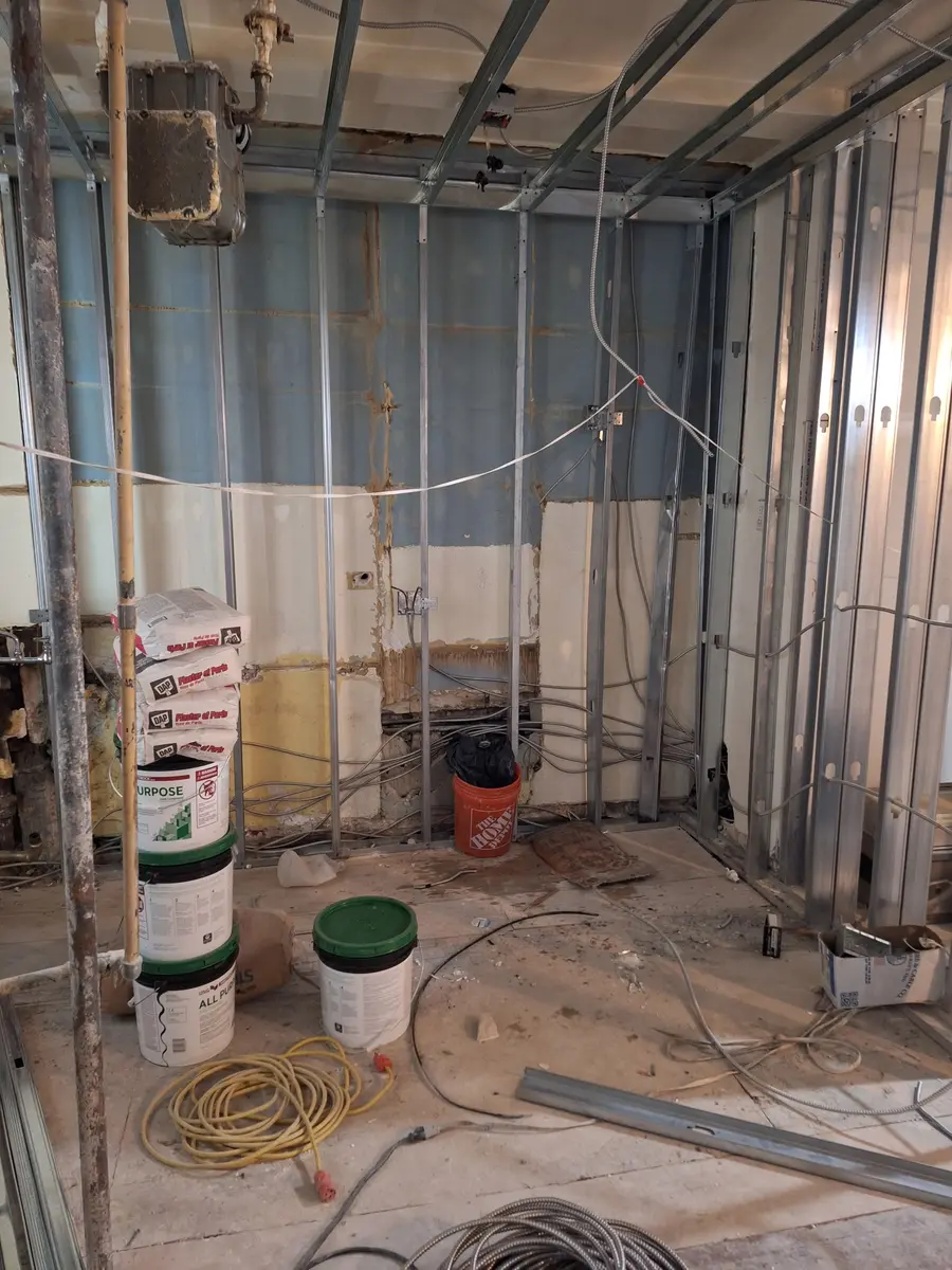 Full apartment rewiring in progress in Astoria, Queens, with new wiring run through opened walls