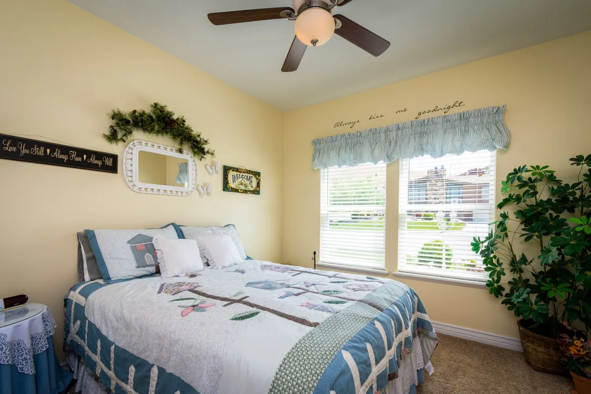 Ceiling fan with light kit installed in a home bedroom by a licensed NYC electrician