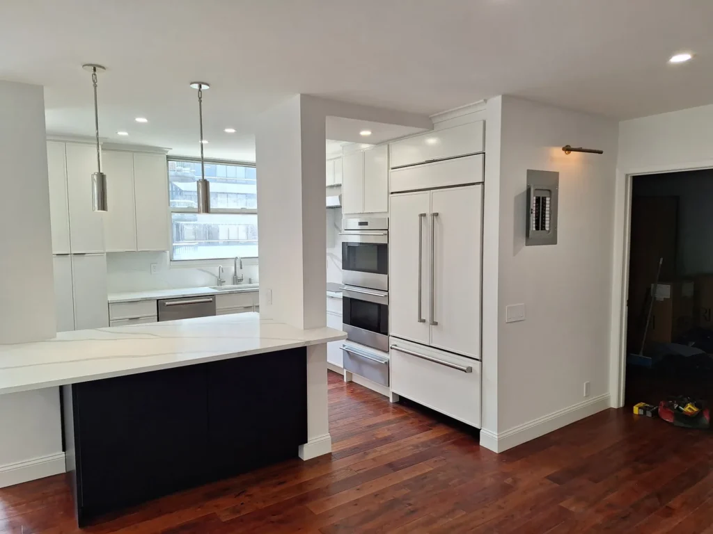 Renovated NYC apartment kitchen wired by AE Electric: pendant lights, recessed lighting, dedicated appliance circuits for wall ovens, and a new electrical panel